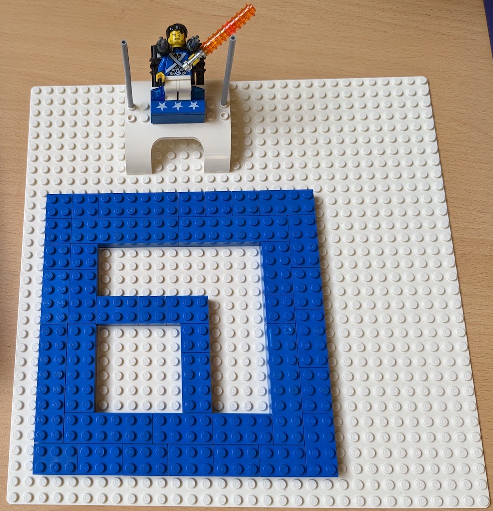 Captain Upvest, a lego minifigure super-hero with a light-saber sits on a throne above a giant Upvest logo